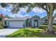 Charming single-story home with a well-manicured lawn, mature landscaping, and attached two-car garage at 4315 Whittner Dr, Land O Lakes, FL 34639
