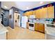 Bright kitchen with white appliances, cabinetry, and an adjacent laundry area at 4315 Whittner Dr, Land O Lakes, FL 34639