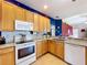 An open kitchen boasts modern appliances and sleek countertops and backsplash at 4315 Whittner Dr, Land O Lakes, FL 34639