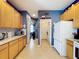 Functional kitchen space featuring tile flooring, cabinets, and access to laundry room at 4315 Whittner Dr, Land O Lakes, FL 34639