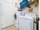Efficient laundry room features a washer, dryer, and storage solutions at 4315 Whittner Dr, Land O Lakes, FL 34639
