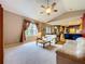 Cozy living room with vaulted ceiling, carpet, and a view into the kitchen at 4315 Whittner Dr, Land O Lakes, FL 34639