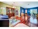 Open living room featuring hardwood floors, a blue accent wall, and lots of natural light at 4315 Whittner Dr, Land O Lakes, FL 34639