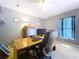 Office space with a computer setup, desk, black chair, and blue accents at 4315 Whittner Dr, Land O Lakes, FL 34639