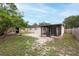 An alternate view of the home's backyard featuring a shed, screened in patio, and a wood privacy fence at 4323 S Lois Ave, Tampa, FL 33611
