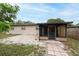 View of the backyard featuring the back of the home and a screened in patio at 4323 S Lois Ave, Tampa, FL 33611