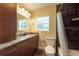 Bathroom highlighting a granite countertop and dark tiled shower at 4323 S Lois Ave, Tampa, FL 33611