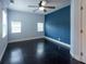 Primary bedroom featuring wood floors, fan and two windows at 4323 S Lois Ave, Tampa, FL 33611
