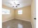 Well-lit bedroom featuring two windows and a ceiling fan at 4323 S Lois Ave, Tampa, FL 33611