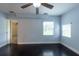 Bright bedroom with wood floors and two windows with natural light at 4323 S Lois Ave, Tampa, FL 33611