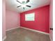 Vibrant bedroom with bright pink walls and a ceiling fan at 4323 S Lois Ave, Tampa, FL 33611