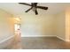 Open bedroom space with speckled flooring and a ceiling fan for comfort at 4323 S Lois Ave, Tampa, FL 33611