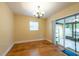 Bright dining area with wood floors and sliding door to patio at 4323 S Lois Ave, Tampa, FL 33611