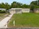 Inviting single-Gathering home featuring a green lawn and a paved driveway at 4323 S Lois Ave, Tampa, FL 33611