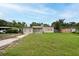 Charming single-story home featuring a well-manicured lawn and inviting entrance at 4323 S Lois Ave, Tampa, FL 33611