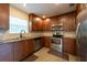 Well-equipped kitchen with stainless steel appliances and ample wooden cabinets at 4323 S Lois Ave, Tampa, FL 33611