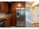 Modern kitchen featuring stainless steel refrigerator, granite countertops and wooden cabinets at 4323 S Lois Ave, Tampa, FL 33611