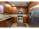 Well-appointed kitchen with stainless steel appliances and sleek wooden cabinetry at 4323 S Lois Ave, Tampa, FL 33611