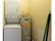 Functional laundry room with a washer, dryer, and water heater at 4323 S Lois Ave, Tampa, FL 33611