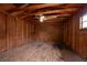 The interior of the home's backyard wood shed features a ceiling fan and room to work at 4323 S Lois Ave, Tampa, FL 33611