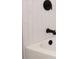 Modern bath with white tile and matte black fixtures on the bathtub faucet at 4572 33Rd N Ave, St Petersburg, FL 33713
