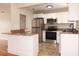 Modern kitchen with stainless steel appliances, granite countertops, and stylish white cabinetry at 4572 33Rd N Ave, St Petersburg, FL 33713