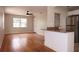 Open-concept living space with hardwood floors, a ceiling fan, and a convenient breakfast bar at 4572 33Rd N Ave, St Petersburg, FL 33713