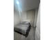 Cozy bedroom featuring a full bed with gray linens and a white headboard, lit by overhead lighting at 4743 Deer Track St, Tampa, FL 33610