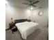 Bright bedroom featuring a queen bed, side tables, a ceiling fan, and a minimalist aesthetic at 4743 Deer Track St, Tampa, FL 33610