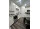 Bright kitchen with white cabinetry, granite countertops, and stainless steel appliances at 4743 Deer Track St, Tampa, FL 33610