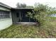 Screened porch adjacent to light green home at 4920 S 82Nd St, Tampa, FL 33619