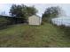 Backyard featuring a shed and adjacent screened porch at 4920 S 82Nd St, Tampa, FL 33619