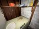 Unfinished basement featuring an old freezer and exposed shelving at 4920 S 82Nd St, Tampa, FL 33619