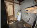 Unfinished basement featuring a new hot water heater and cinder block walls at 4920 S 82Nd St, Tampa, FL 33619