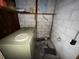 Unfinished basement featuring cinder block walls and an old freezer at 4920 S 82Nd St, Tampa, FL 33619
