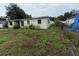 Side view of the light green single-story house with chain link fence at 4920 S 82Nd St, Tampa, FL 33619