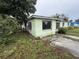 Exterior view of single-story home featuring a cinder block construction and minimal landscaping at 4920 S 82Nd St, Tampa, FL 33619