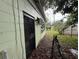 Side view of the back of the home and a decorative metal security door at 4920 S 82Nd St, Tampa, FL 33619