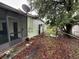 View of the back of the house with foliage and satellite dish at 4920 S 82Nd St, Tampa, FL 33619