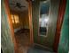 Hallway with view of a bedroom features a ceiling fan and window at 4920 S 82Nd St, Tampa, FL 33619