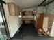 View of a kitchen in need of repairs with dated cabinets and peeling walls at 4920 S 82Nd St, Tampa, FL 33619