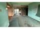 A view of the unfurnished living room with dirty carpet leading to the kitchen at 4920 S 82Nd St, Tampa, FL 33619
