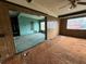Living room features an open layout with paneled walls and ceiling fan at 4920 S 82Nd St, Tampa, FL 33619