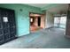 An empty living room with green walls, damaged carpet, and an open doorway at 4920 S 82Nd St, Tampa, FL 33619