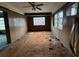 Living room features an open layout with paneled walls and ceiling fan at 4920 S 82Nd St, Tampa, FL 33619