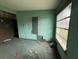 Living room view with dirty carpet, peeling wall paper and window with natural light at 4920 S 82Nd St, Tampa, FL 33619
