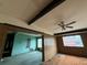 Living room features an open layout with paneled walls and ceiling fan at 4920 S 82Nd St, Tampa, FL 33619