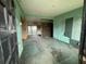 Unfurnished living room with green walls, dirty carpet and doorways to other rooms at 4920 S 82Nd St, Tampa, FL 33619