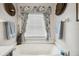 Soaking tub with decorative window treatments and matching wall decor at 5143 Lochmead Ter, Zephyrhills, FL 33541