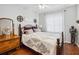 Cozy bedroom with a comfortable queen-sized bed and hardwood floors at 5143 Lochmead Ter, Zephyrhills, FL 33541